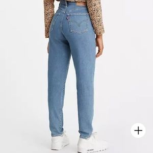 Levi’s Wedgie High Waisted, Snug though hip and thigh, Tapered leg.